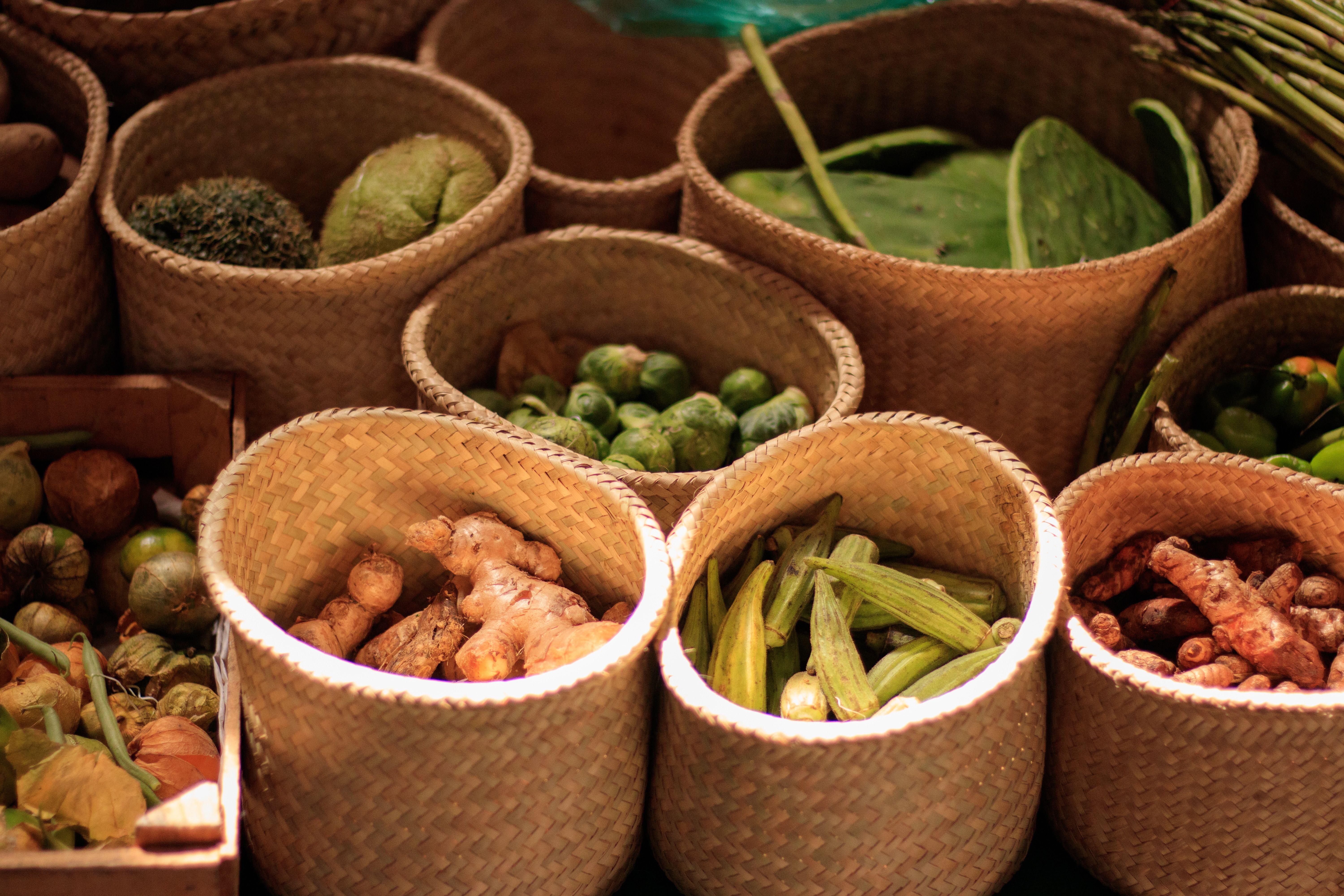 Farmer's hands holding a harvest basket of vegetables